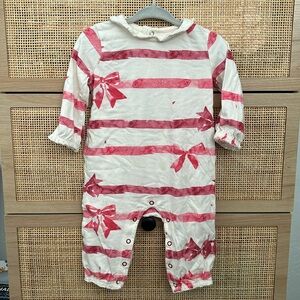 Burt’s Bee’s holiday bow romper with ruffles at neck, arm and leg openings